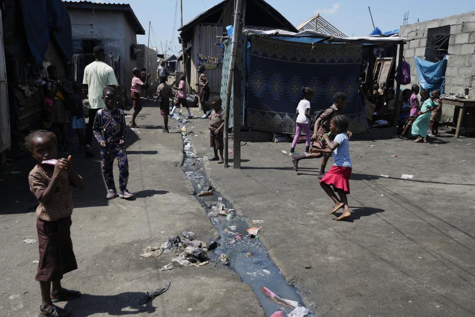 Children play around sewage water in Nigeria's economic capital Lagos' floating slum of Makoko, Monday, March. 20, 2023. March 22 is World Water Day, established by the United Nations and marked annually since 1993 to raise awareness about access to clean water and sanitation. (AP Photo/Sunday Alamba)