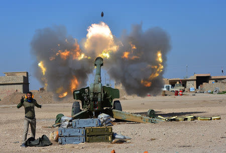 Popular Mobilization Forces (PMF) fires towards Islamic State militants during a battle with Islamic State militants, west of Mosul,Iraq February 22, 2017. REUTERS/Stringer