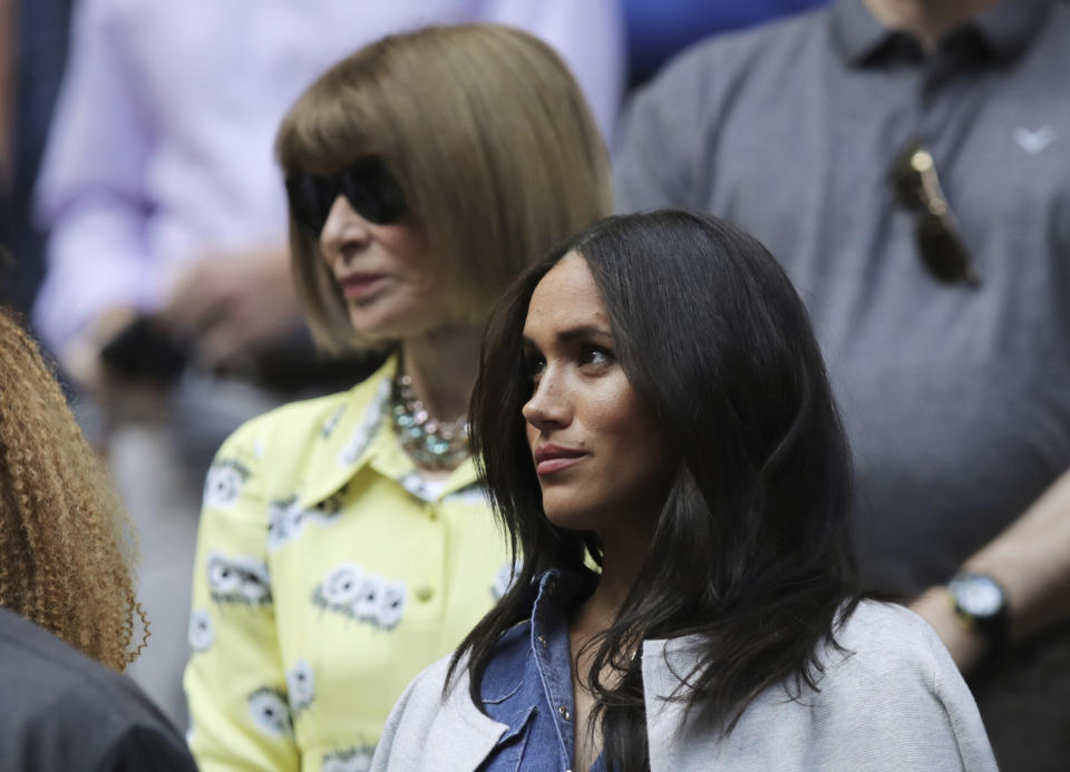 Meghan, Duchess of Sussex, right, and Anna Wintour wait for the start of the women's singles final of the U.S. Open tennis championships between Serena Williams, of the United States, and Bianca Andreescu, of Canada, Saturday, Sept. 7, 2019, in New York. (AP Photo/Charles Krupa)