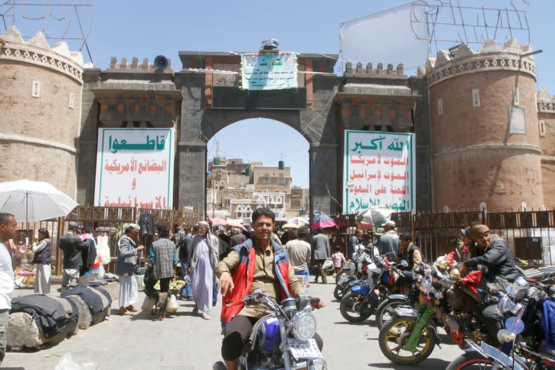 People shop at a market in the old quarter of Sanaa