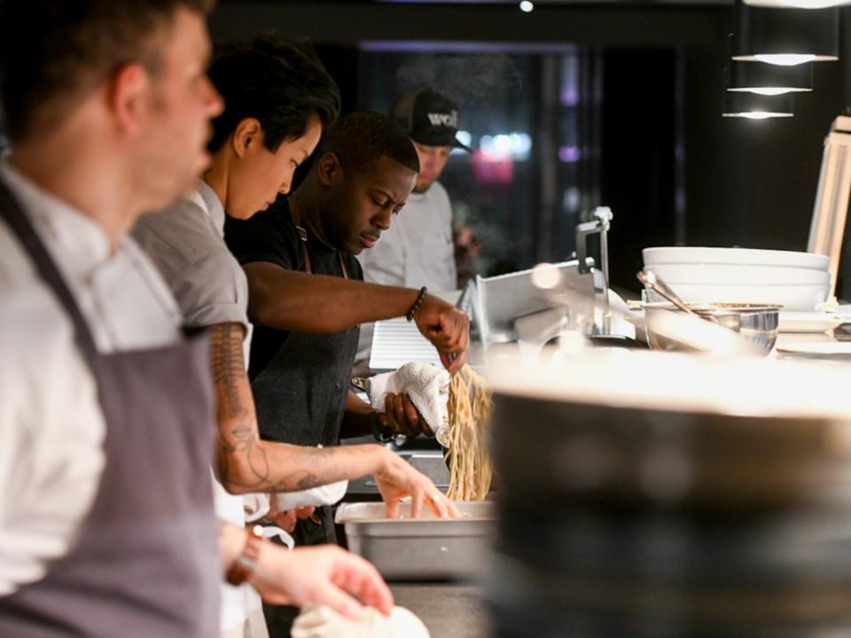 Cooks at an assembly line.