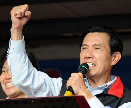 Taiwan President Ma Ying-jeou clinches his fist as he campaigns for re-election in Hsinchu on January 10, 2012 ahead of the January 14 presidential election