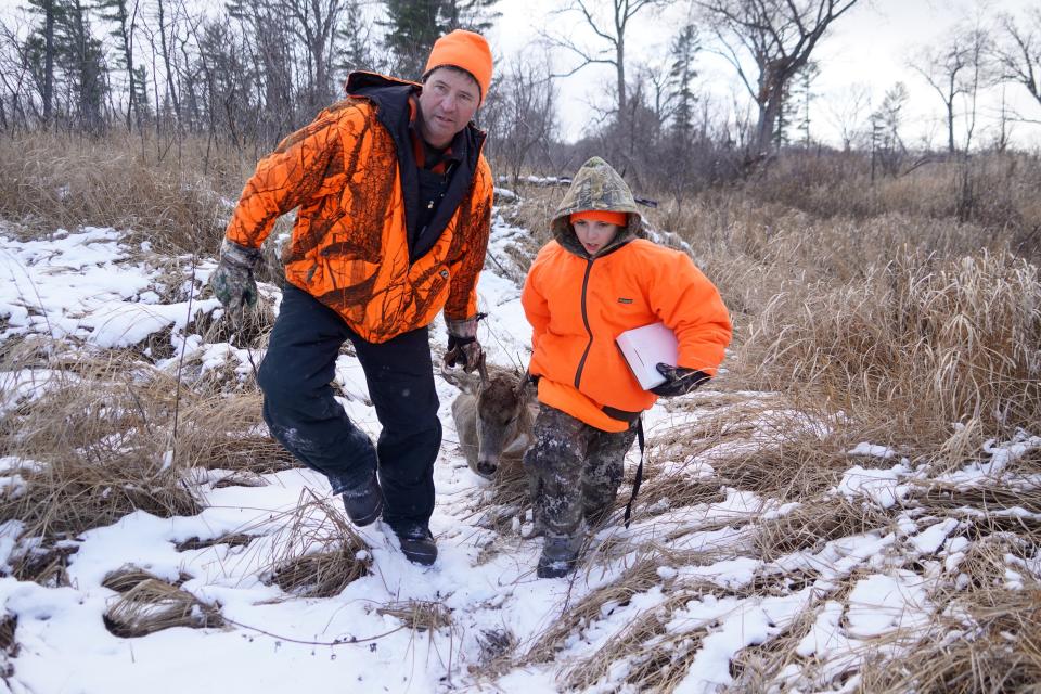 Brian Weigel, left and his son Sawyer Weigel, both of Sauk City, drag a 10-point buck shot by Sawyer during a Nov. 19 hunt on the Leopold-Pines Conservation Area near Baraboo.