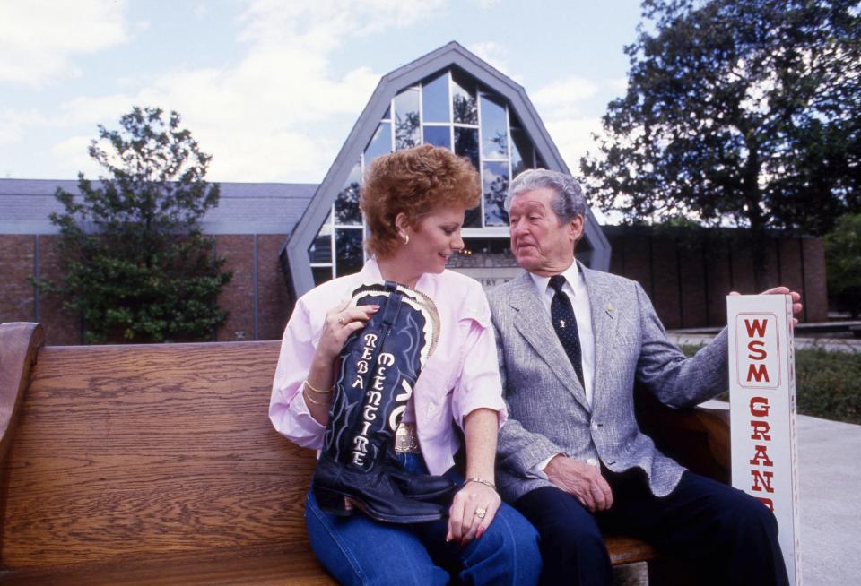 Reba McEntire, the newest member of the Grand Ole Opry, and Roy Acuff, the king of country music, show off items that are part of the Country Music Hall of Fame and Museum's newest exhibit, 