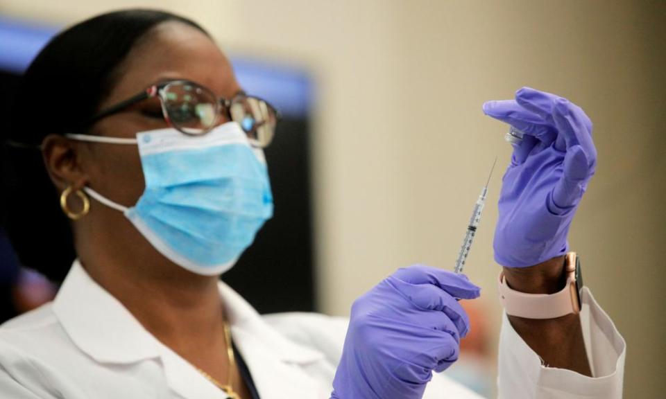 A doctor administer a Pfizer vaccine in Long Island, New York.