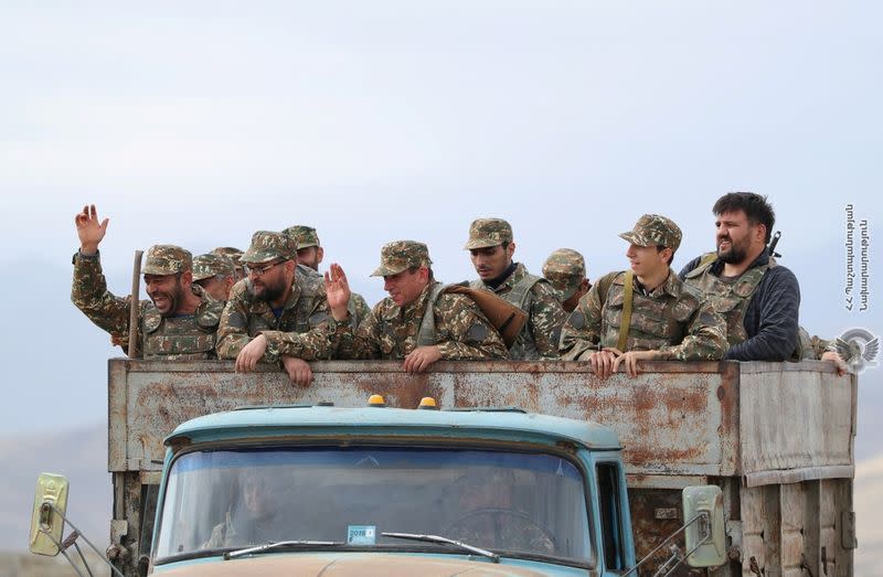 Ethnic Armenian soldiers are seen in a vehicle during fighting with Azerbaijan's forces in Nagorno-Karabakh