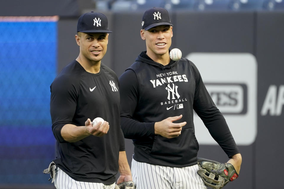 New York Yankees' Giancarlo Stanton, left, and Aaron Judge, right, work out ahead of Game 1 of baseball's American League Division Series against the Cleveland Guardians, Monday, Oct. 10, 2022, in New York. (AP Photo/John Minchillo)