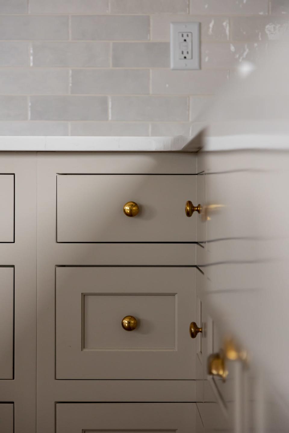 The new drawers and cabinetry in this renovated kitchen at a home in Prospect feature unlacquered brass hardware.