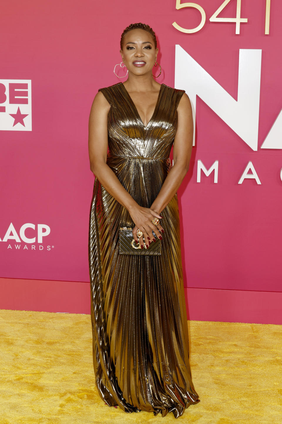 MC Lyte wearing gold gown. 