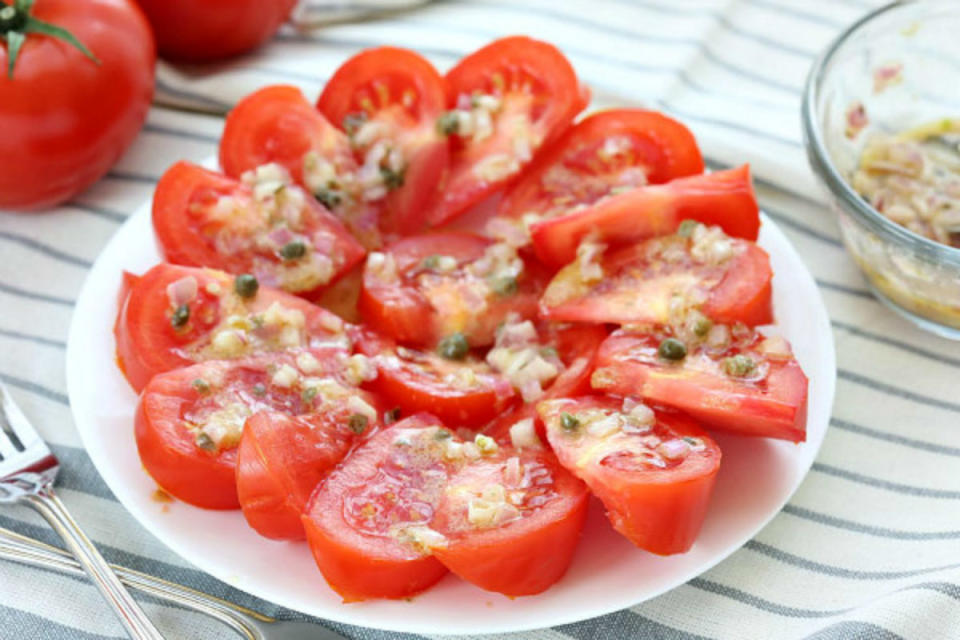 <p>Recipe Girl</p><p>Fresh tomatoes are topped with a simple, tangy vinaigrette and capers.</p><p><strong>Recipe here:</strong> <strong><a href="http://www.recipegirl.com/2008/11/10/shallot-mustard-tomato-salad/" rel="nofollow noopener" target="_blank" data-ylk="slk:Shallot Mustard Tomato Salad;elm:context_link;itc:0;sec:content-canvas" class="link ">Shallot Mustard Tomato Salad</a></strong></p>