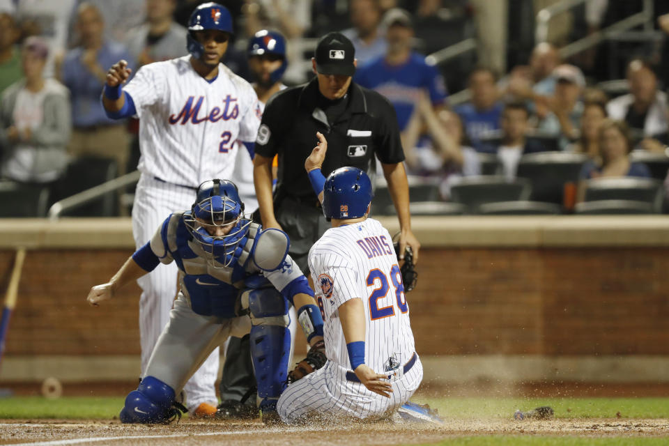 Los Angeles Dodgers catcher Will Smith, beflow left, applies a late tag on New York Mets' J.D. Davis, (28) who scores on Brandon Nimmo's two-run triple during the second inning of a baseball game, Sunday, Sept. 15, 2019, in New York. Mets' Robinson Cano, above left, also scored on the play. Home plate umpire Vic Carapazza watches the plate. (AP Photo/Kathy Willens)