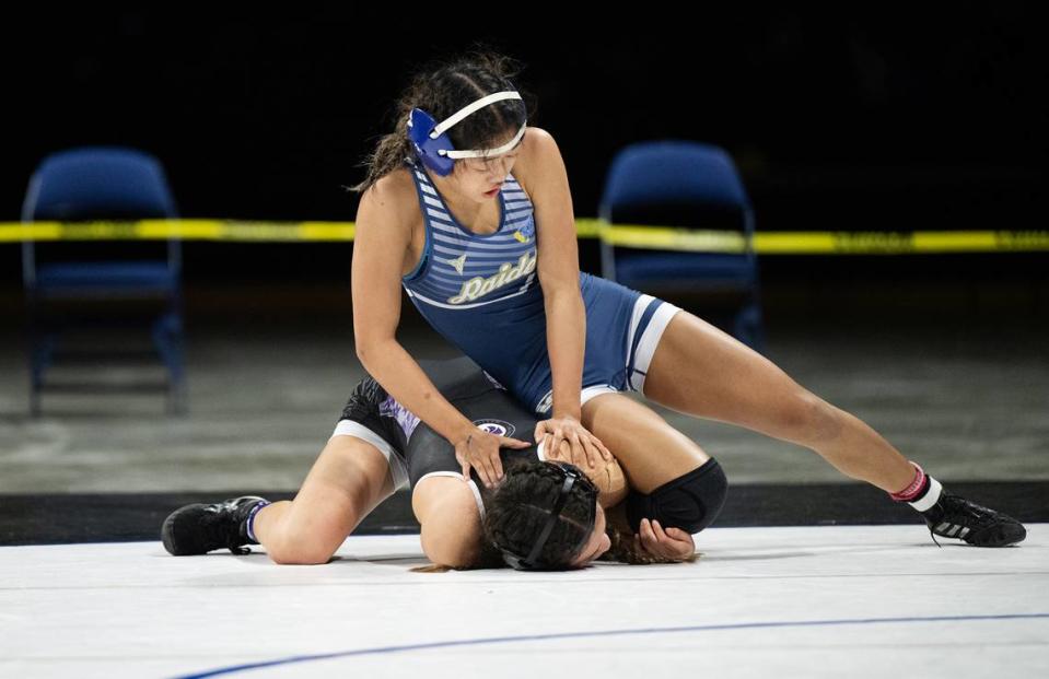 Central Catholic’s Jillian Wells holds down Giselle Solano of Franklin (Elk Grove) in the 100-pound championship match during the Sac-Joaquin Section Masters Wrestling Championships at Stockton Arena in Stockton, Calif., Saturday, Feb. 17, 2024. Wells won the title 8-0.