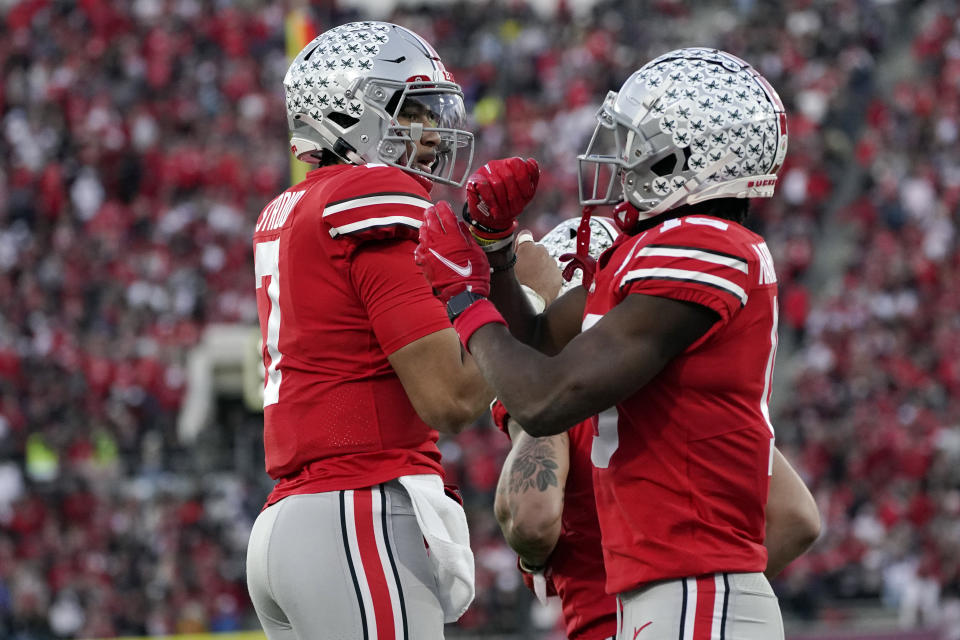 Ohio State wide receiver Jaxon Smith-Njigba, right, celebrates his touchdown catch with quarterback C.J. Stroud during the second half in the Rose Bowl NCAA college football game against Utah Saturday, Jan. 1, 2022, in Pasadena, Calif. (AP Photo/Mark J. Terrill)