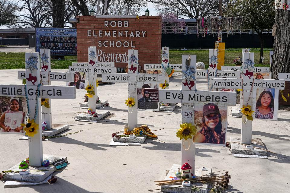 Crosses dedicated to the 21 victims of the 2022 mass shooting stand in front of Uvalde's Robb Elementary School.