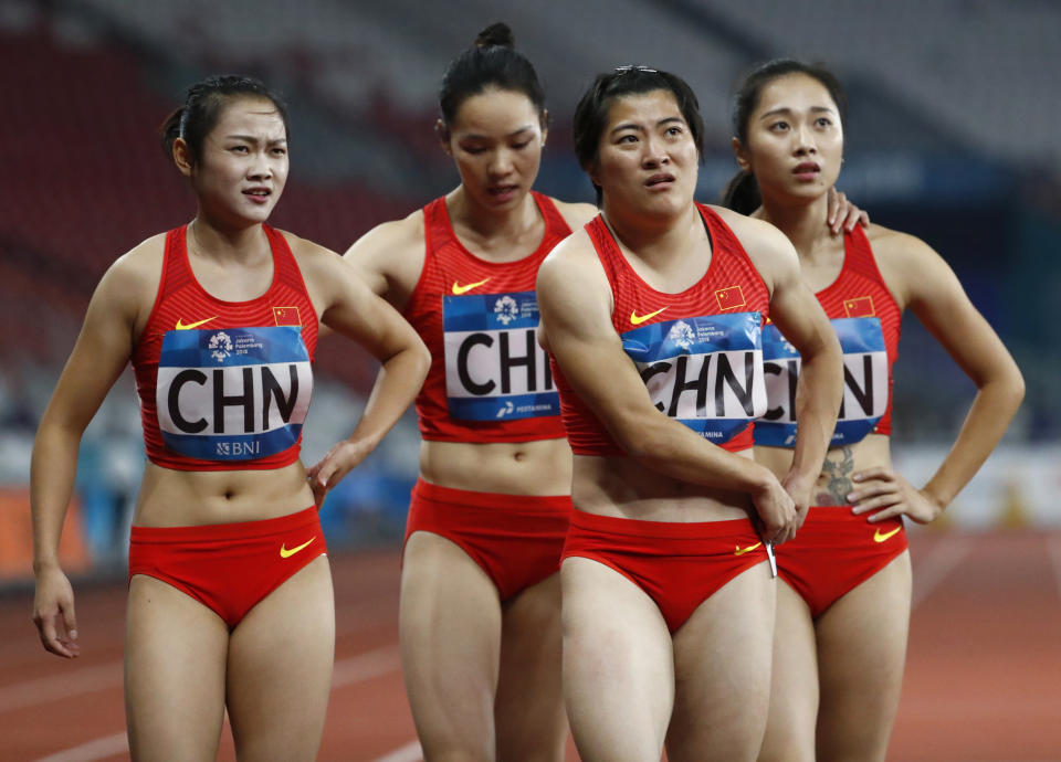 China's women's 4x100m relay team react after their second place finish during the athletics competition at the 18th Asian Games in Jakarta, Indonesia, Thursday, Aug. 30, 2018. (AP Photo/Bernat Armangue)