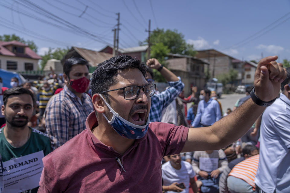 Kashmiri Hindus, locally known as Pandits, shout slogans during a protest against the killing of Rahul Bhat, also a Pandit, on the outskirts of Srinagar, Indian controlled Kashmir, Friday, May 13, 2022. Hindus in Indian-controlled Kashmir staged protests on Friday a day after assailants shot and killed the government employee from the minority community. It was the first time that Pandits, an estimated 200,000 of whom fled Kashmir after an anti-India rebellion erupted in 1989, simultaneously organized street protests at several places in the Muslim-majority region. (AP Photo/Dar Yasin)