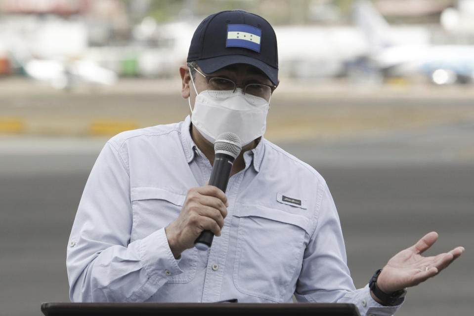 Honduran President Juan Orlando Hernandez during a ceremony at an air base to receive a shipment of the AstraZeneca COVID-19 vaccine via the COVAX program, in Tegucigalpa, Honduras, Saturday, March 13, 2021. (AP Photo/Elmer Martinez)