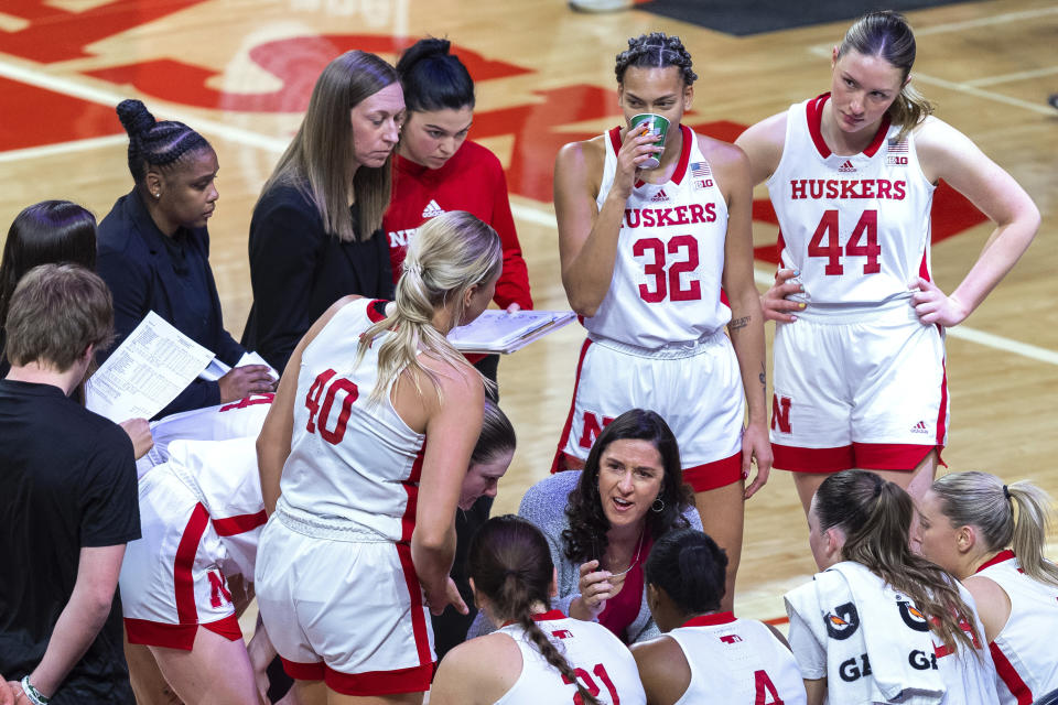 Nebraska coach Amy Williams speaks with the team during a timeout in the first half of the team's NCAA college basketball game against Nebraska on Wednesday, Dec. 21, 2022, in Lincoln, Neb. (Kenneth Ferriera/Lincoln Journal Star via AP)