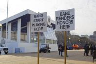 Signs with instructions for parade participants are seen along Pennsylvania Avenue, in Washington, Sunday, Jan. 15, 2017, in preparation for the presidential inauguration on Friday, Jan. 20. (AP Photo/Pablo Martinez Monsivais)