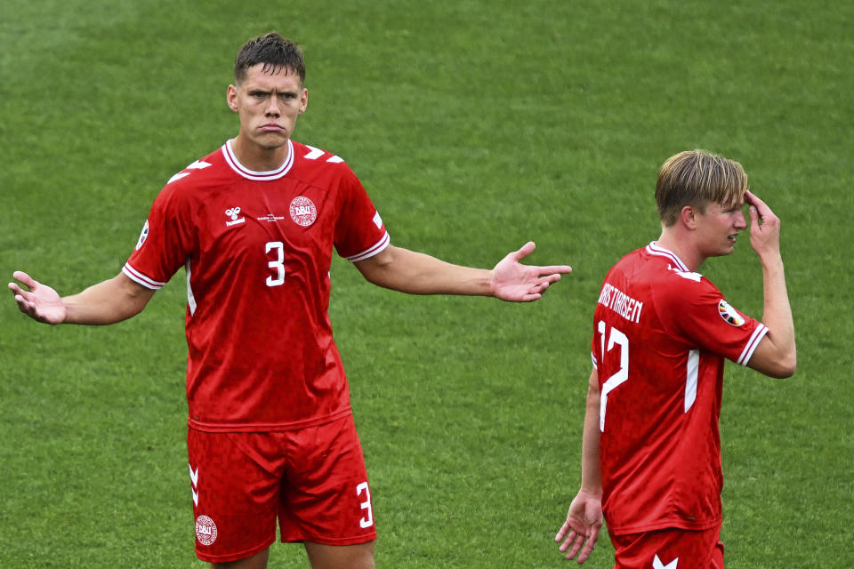 Denmark's Jannik Vestergaard, left, and Victor Kristiansen, right, react during a Group C match between Slovenia and Denmark at the Euro 2024 soccer tournament in Stuttgart, Germany, Sunday, June 16, 2024. (Bernd Weissbrod/dpa via AP)