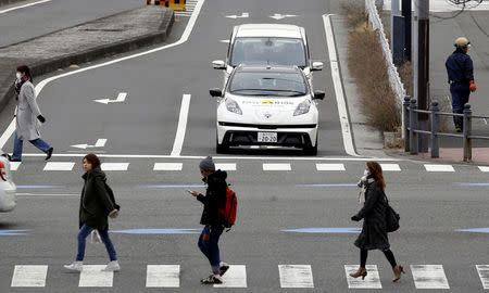 A self-driving vehicle, based on Nissan Leaf electric vehicle (EV), for Easy Ride service, developed by Nissan and mobile gaming platform operator DeNA Co, is seen during its media preview in Yokohama, Japan, February 21, 2018. Picture taken February 21, 2018. REUTERS/Toru Hanai