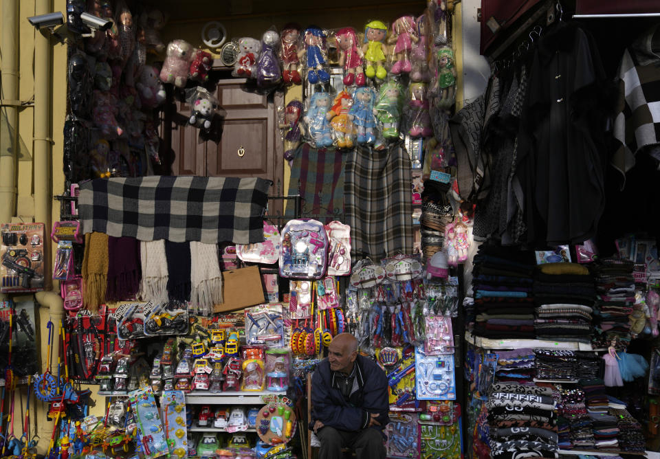 A vendor sits in front of toys displayed for sale in a street market in Istanbul, Turkey, Monday, May 8, 2023. Turkey's presidential and parliamentary elections on Sunday are taking place amid rampant inflation and months after a catastrophic earthquake killed over 50,000 people in the country's south. The government has come under criticism for mismanaging the economy and failing to prepare the quake-prone nation for February's natural disaster. (AP Photo/Khalil Hamra)