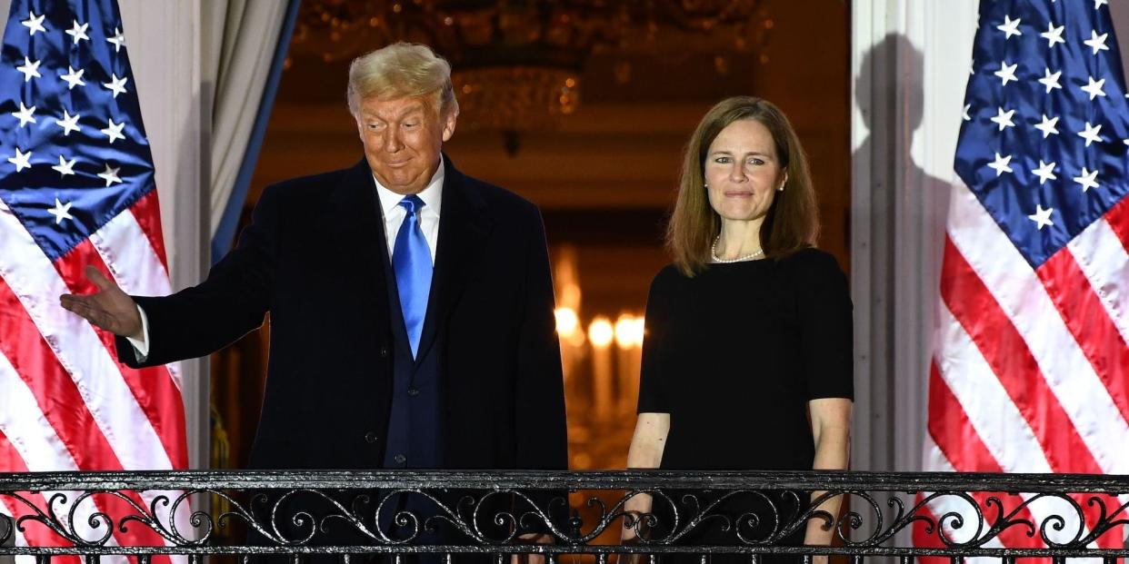 Trump stands with now-Justice Amy Coney Barrett at the White House after she was sworn in on October 26, 2020.