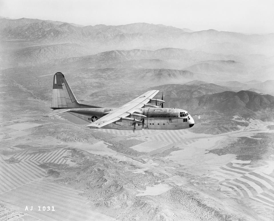 a  large plane flying over the mountains in California