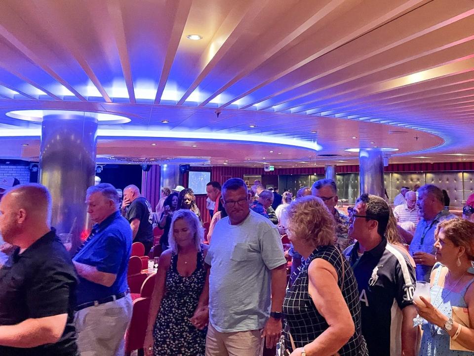 Crowds leave the auditorium after a comedy show on the Carnival Vista.