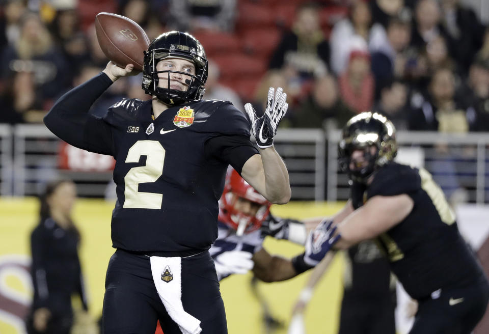 Purdue quarterback Elijah Sindelar, left, throws against Arizona during the first half of the Foster Farms Bowl NCAA college football game Wednesday, Dec. 27, 2017, in Santa Clara, Calif. (AP Photo/Marcio Jose Sanchez)