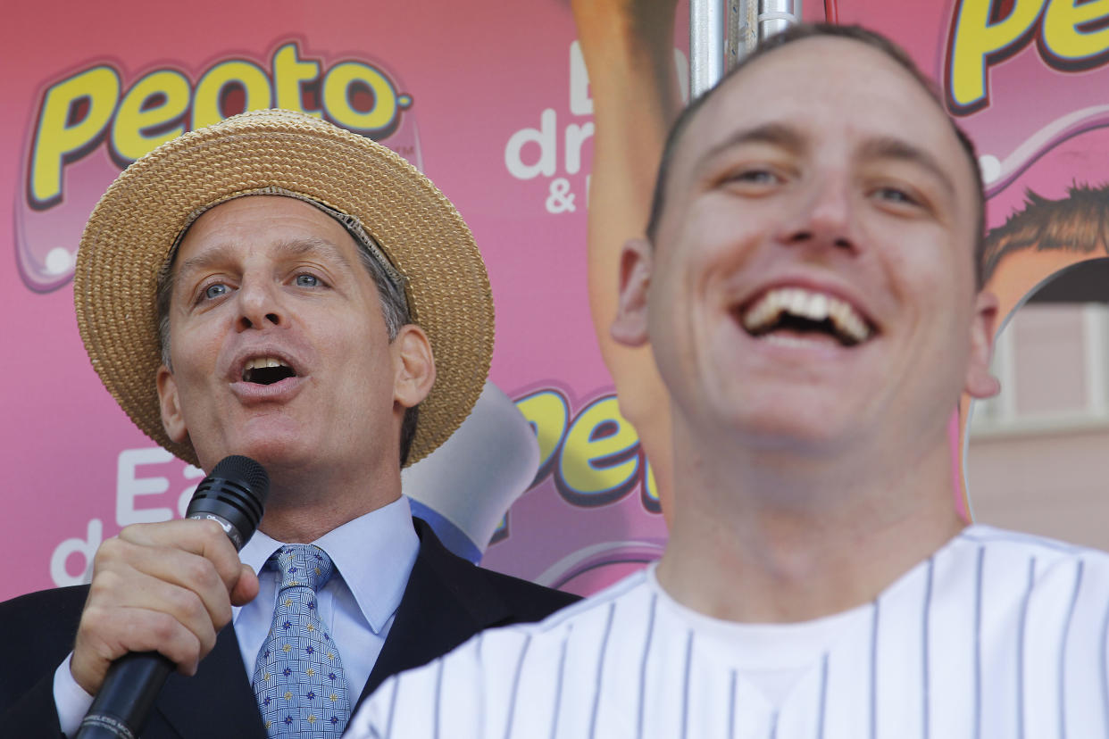 In this photograph taken by AP Images for Pepto Bismol, George Shea, left, announces World eating champion Joey Chestnut, before competing in a taco eating contest sponsored by Pepto-Bismol at the San Francisco Street Food Festival on Saturday, Aug. 21, 2010 in San Francisco. (Tony Avelar / AP Images for Pepto-Bismol)