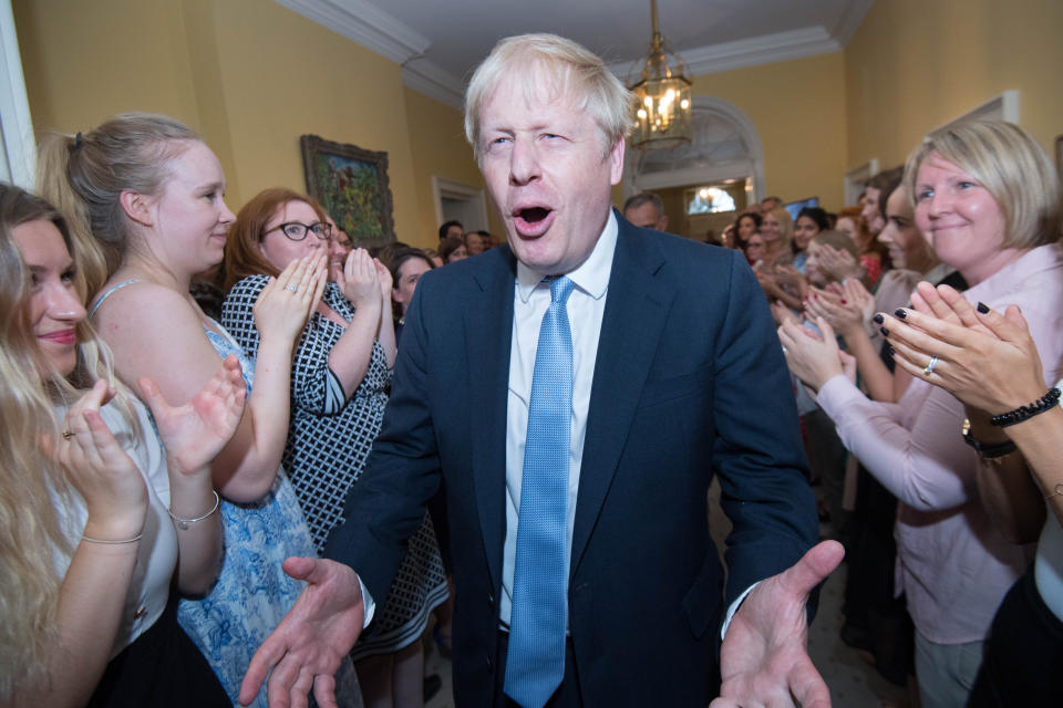 Prime Minister Boris Johnson is clapped into 10 Downing Street by staff after seeing Queen Elizabeth II and accepting her invitation to become Prime Minister and form a new government.