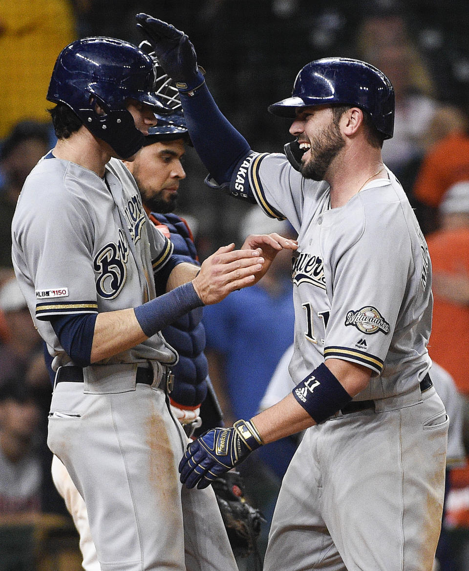 Milwaukee Brewers' Mike Moustakas, right, celebrates his two-run home run off Houston Astros relief pitcher Cionel Perez with Christian Yelich during the 14th inning of a baseball game Wednesday, June 12, 2019, in Houston. (AP Photo/Eric Christian Smith)