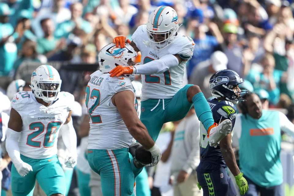 Miami Dolphins safety Jordan Poyer (21) celebrates with defensive tackle Zach Sieler (92) after Sieler made an interception against the Seattle Seahawks during the second half of an NFL football game Sunday, Sept. 22, 2024, in Seattle. (AP Photo/Lindsey Wasson)