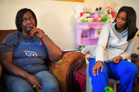 Quinta Sanders and friend Tiffany Reynolds sit in the living room of Sanders' home while speaking with Reuters in Nashville, Tennessee, U.S. October 10, 2017. Picture taken October 10, 2017. REUTERS/Harrison McClary