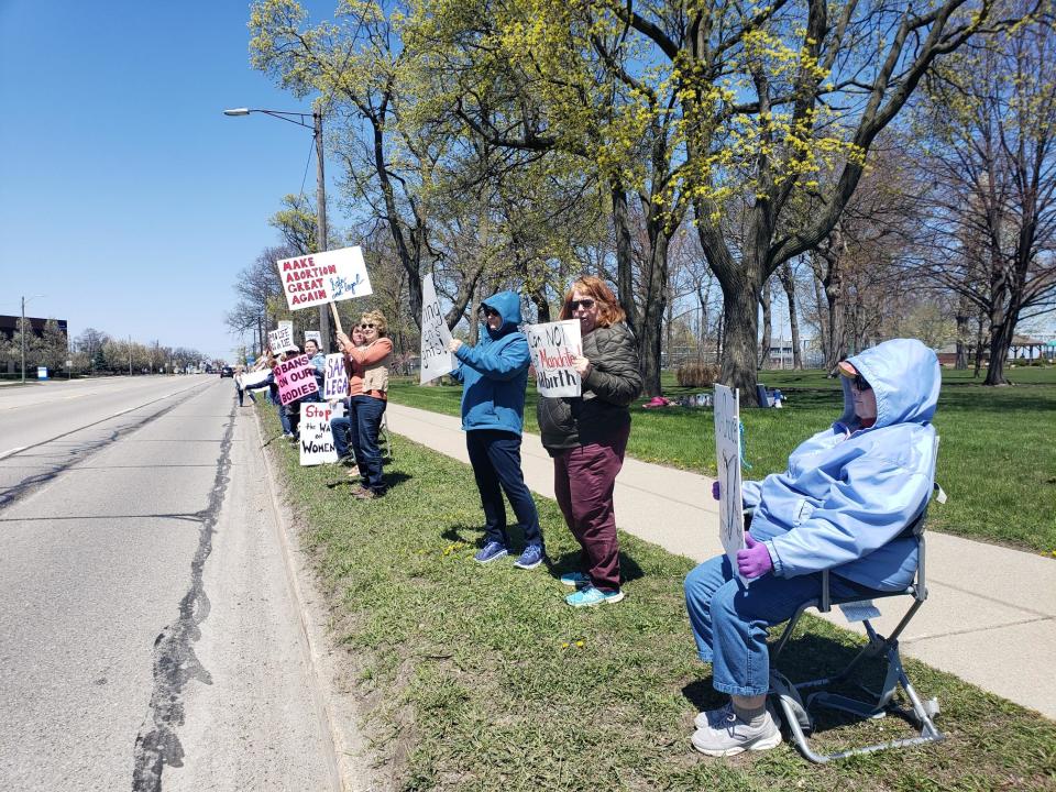 Demonstrators hold signs at an abortion rights demonstration in Pine Grove Park Saturday, May 7, 2022.