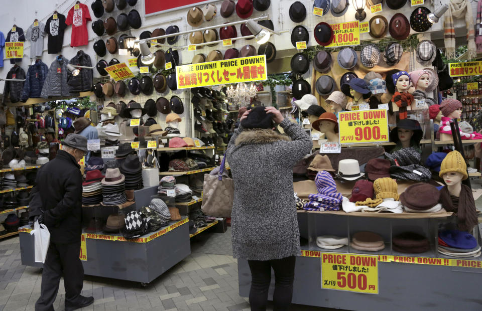 In this Monday, Feb. 17, 2014 photo, a woman tries out a hut for sale a discount store in Tokyo. Japan's consumer price index rose 1.3 percent in January and factory production also climbed, suggesting the recovery in the world's third-largest economy is holding steady ahead of an April 1 tax hike. A raft of data released Friday suggest the economy may need still more help in weathering the 3 percent tax increase in April as many economists forecast a contraction will follow as consumers and businesses adjust to higher costs. (AP Photo/Shizuo Kambayashi)