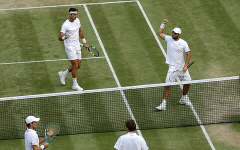 Colombia's Juan Sebastian Cabal and Robert Farah, top, celebrate winning a game against France's Nicolas Mahut and Edouard Roger-Vasselin during the men's doubles final match on day twelve of the Wimbledon Tennis Championships in London, Saturday, July 13, 2019. - Credit: AP