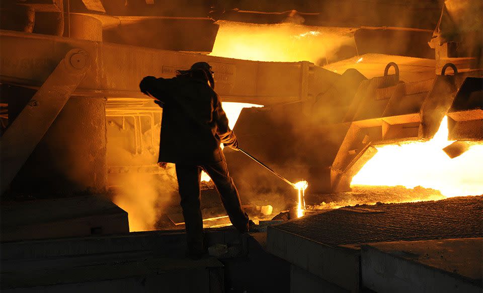 A worker takes sample of iron for further checks. This iron is to be processed into steel. (Credit: Severstal)