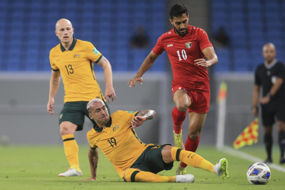 Jordan's Mousa Suleiman right, and Australia's Alan Davidson fight for the ball during a friendly soccer match between Jordan and Australia in Doha, Qatar, Wednesday, June 1, 2022. (AP Photo/Hussein Sayed)