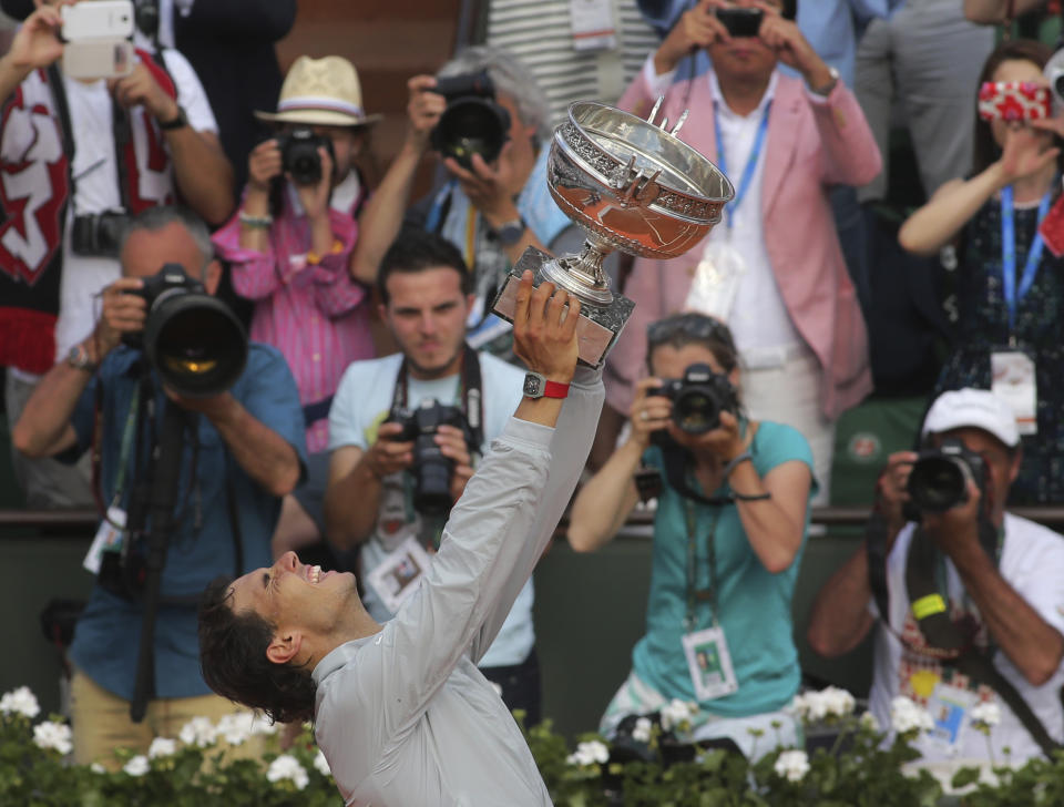 FILE - In this June 8, 2014, file photo, Spain's Rafael Nadal holds the trophy after winning the final of the French Open tennis tournament against Serbia's Novak Djokovic at Roland Garros stadium, in Paris. Nadal will be trying to win his record-extending 13th championship at the clay-court major tournament when play begins on Sunday, Sept. 27, 2020 (AP Photo/Thibaut Camus, File)