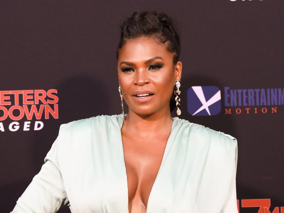 Nia Long on the red carpet wearing a white suit