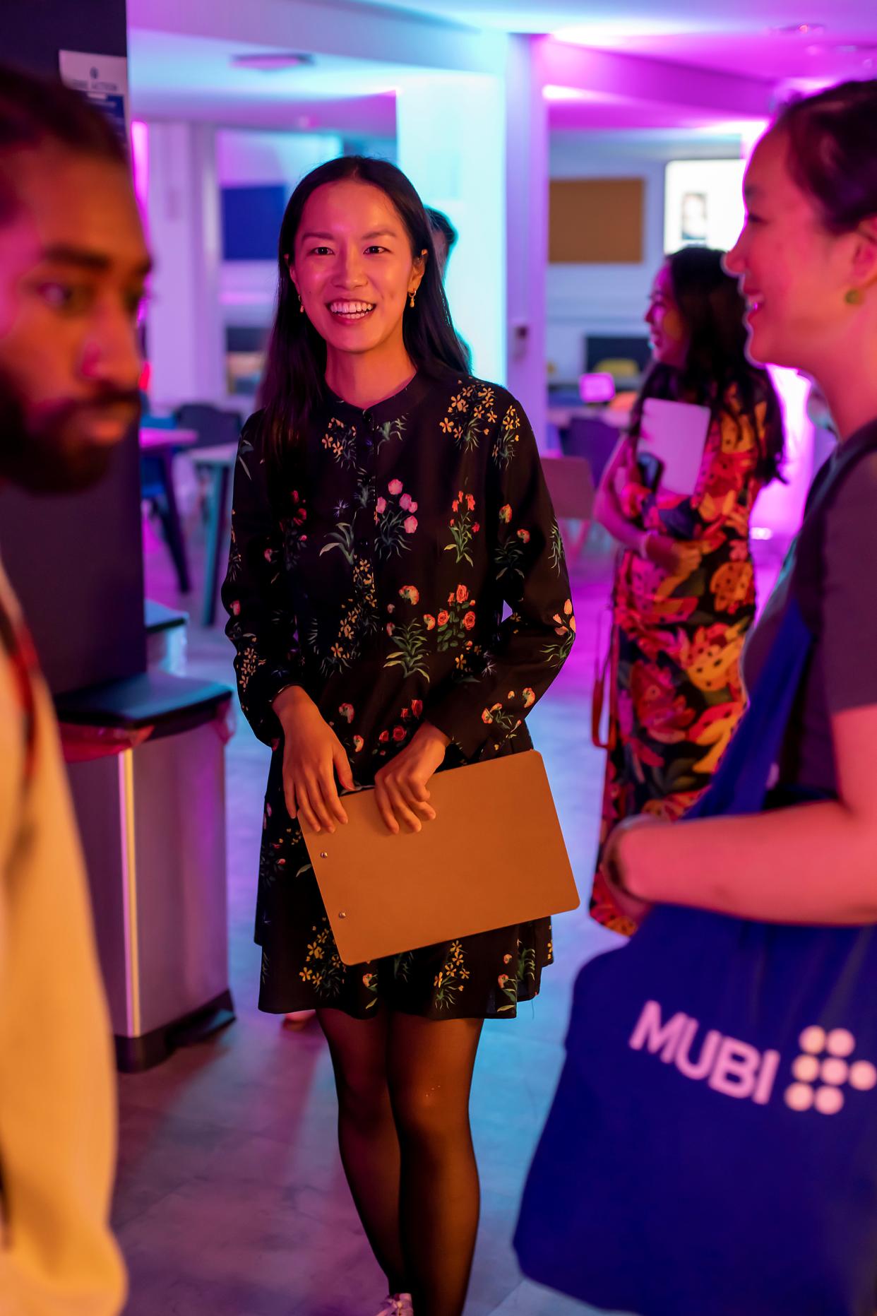 Peiwen Tian smiling with people in the background