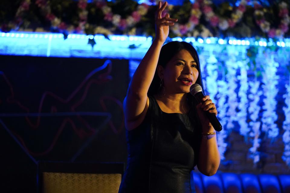 Filipina comedian Imah Dumagay performs stand-up comedy at an open-mic night at the Hi Five Restaurant & Lounge in Dubai, United Arab Emirates, Sunday, Aug. 8, 2021. Tucked within her slightly risqué set, Dumagay's rapid-fire punchlines offer an unfiltered glimpse into the life, sly triumphs and slights faced by her 2.2 million compatriots working in the Middle East. They send billions of U.S. dollars in remittances back to their families still living in the Philippines, but live in countries that often treat them as a disposable, low-paid workforce. (AP Photo/Jon Gambrell)