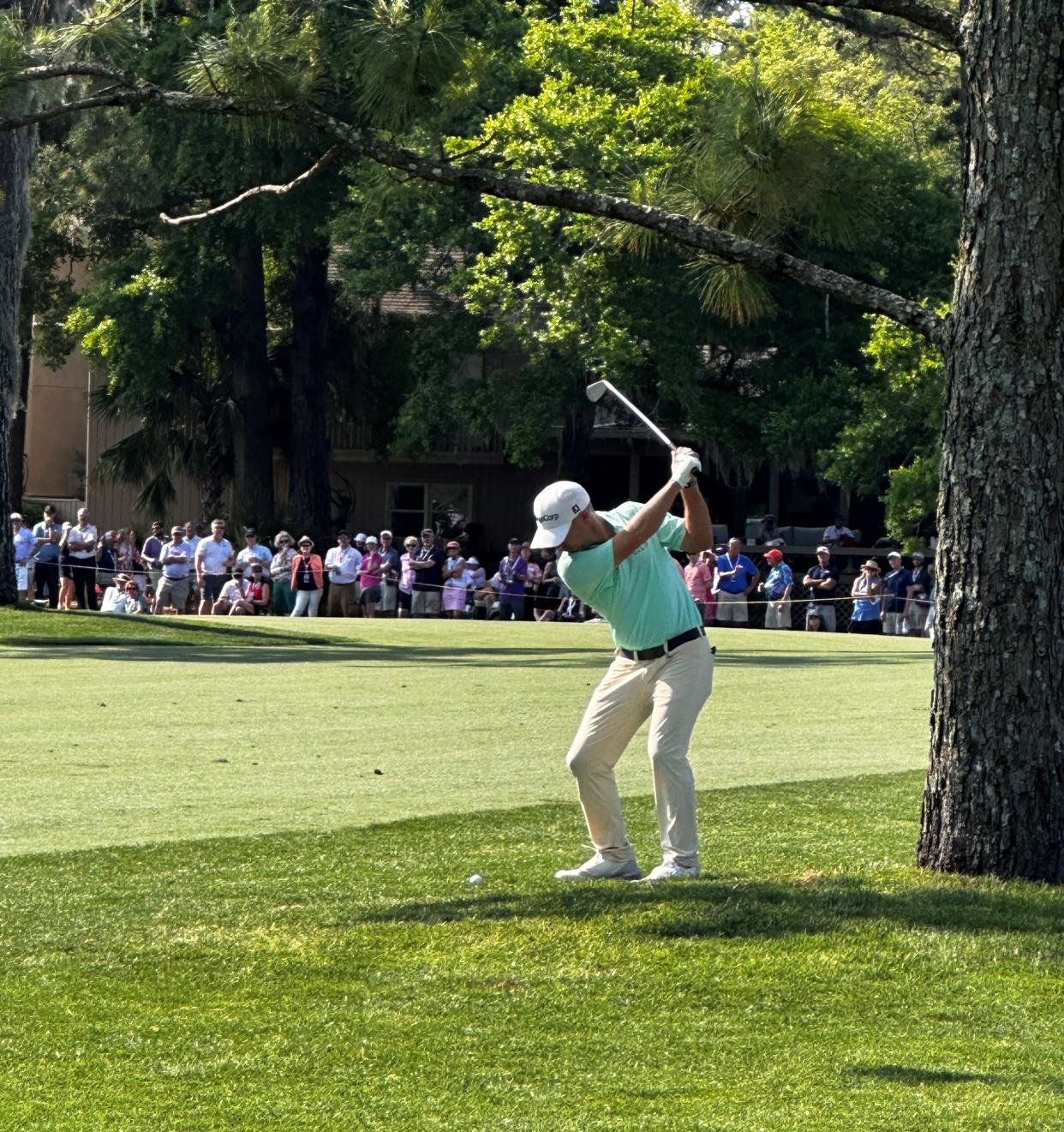 Brian Harman hits his approach shot to the 16th green at Harbour Town Golf Links during the first round of the RBC Heritage Tournament on April 18, 2024.