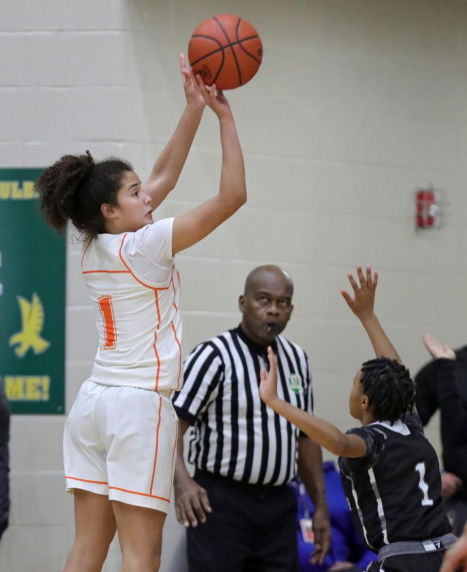 Ellet's Caitlyn Holmes, left, shoots a three over Buchtel's Myah Clark during the first half of a high school basketball game, Wednesday, Jan. 31, 2024, in Akron, Ohio.