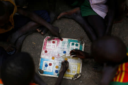 Children play a board game in the United Nations Mission in South Sudan (UNMISS) Protection of Civilian site (CoP), near Bentiu, northern South Sudan, February 9, 2017. REUTERS/Siegfried Modola