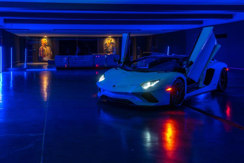 A deep blue colored car showroom in the Star Resort with a Lamborghini