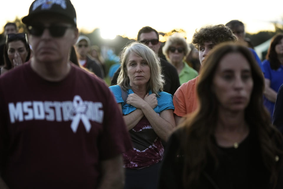 People attend a community commemoration ceremony for the 17 students and staff of Marjory Stoneman Douglas High School who were killed at the Parkland, Fla., school, on the five-year anniversary of the shooting, Tuesday, Feb. 14, 2023, at Pine Trails Park in Parkland. Family members, neighbors, and well wishers turned out to multiple events Tuesday to honor the lives of those killed on Valentine's Day 2018. (AP Photo/Rebecca Blackwell)