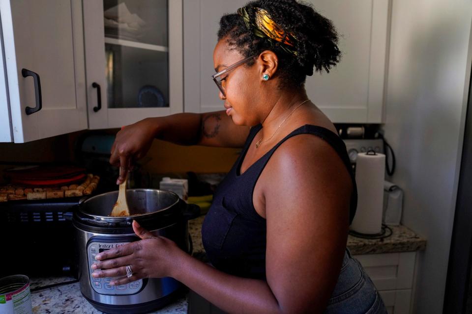 Alisha Washington, 30, in her kitchen in Detroit on Friday, Aug. 18, 2023. "My kitchen is a place of recovery me, and struggle," Washington said. "Having disordered eating when you love food is such a weird thing because I love cooking, I love cooking for people, I love feeding people, but you might make a full meal and be like I don't want to eat any of this." Washington said one of her favorite things to make is brownies. "I will die saying boxed brownies are better than homemade," she said.
